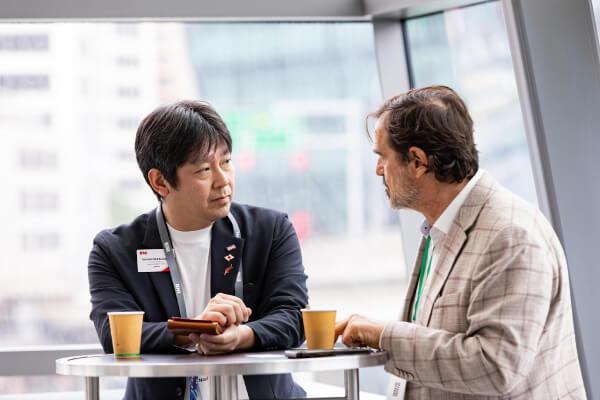 Two men sitting at a table talking